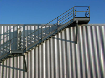 Staircase on corrugated metal building. 11th Street Southeast, Calgary. 25 September 2002. Copyright © 2002 Grant Hutchinson