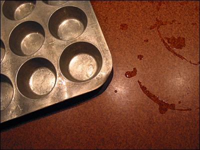 Aluminum muffin pan on kitchen counter. Calgary. 20 February 2003. Copyright © 2003 Grant Hutchinson