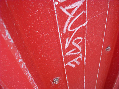 Graffiti on metal fence. Kensington Road, Calgary. 09 June 2004. Copyright © 2004 Grant Hutchinson
