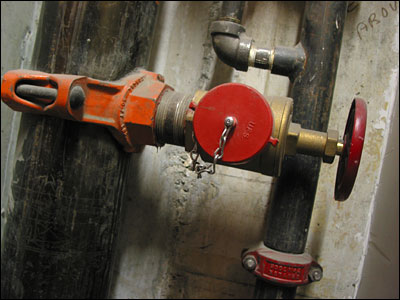 Water valve in stairwell. 4th Street and 8th Avenue Southwest, Calgary. 14 February 2002. Copyright © 2002 Grant Hutchinson