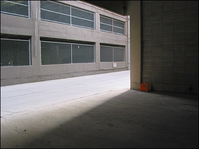 Milk crate in parking stall. 4th Avenue Southwest, Calgary. 01 May 2002. Copyright © 2002 Grant Hutchinson