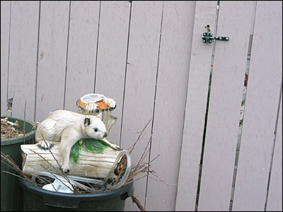 Ceramic squirrel protecting the trash. Southeast Calgary. 14 May 2002. Copyright © 2002 Grant Hutchinson