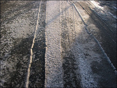 Treadmarks in frozen slush. Heritage Drive Southeast, Calgary. 17 March 2003. Copyright © 2003 Grant Hutchinson